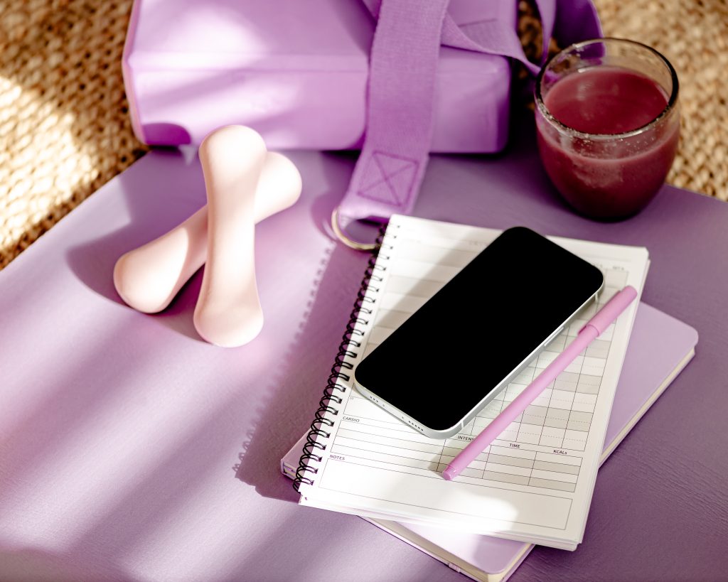 weights, yoga strap, phone, arranged aesthetically